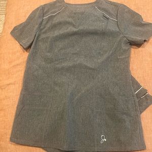 Jaanuu scrub set. Small top, medium bottom. Never worn .Bottoms still have tags.